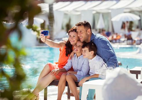 Family taking picture by the pool